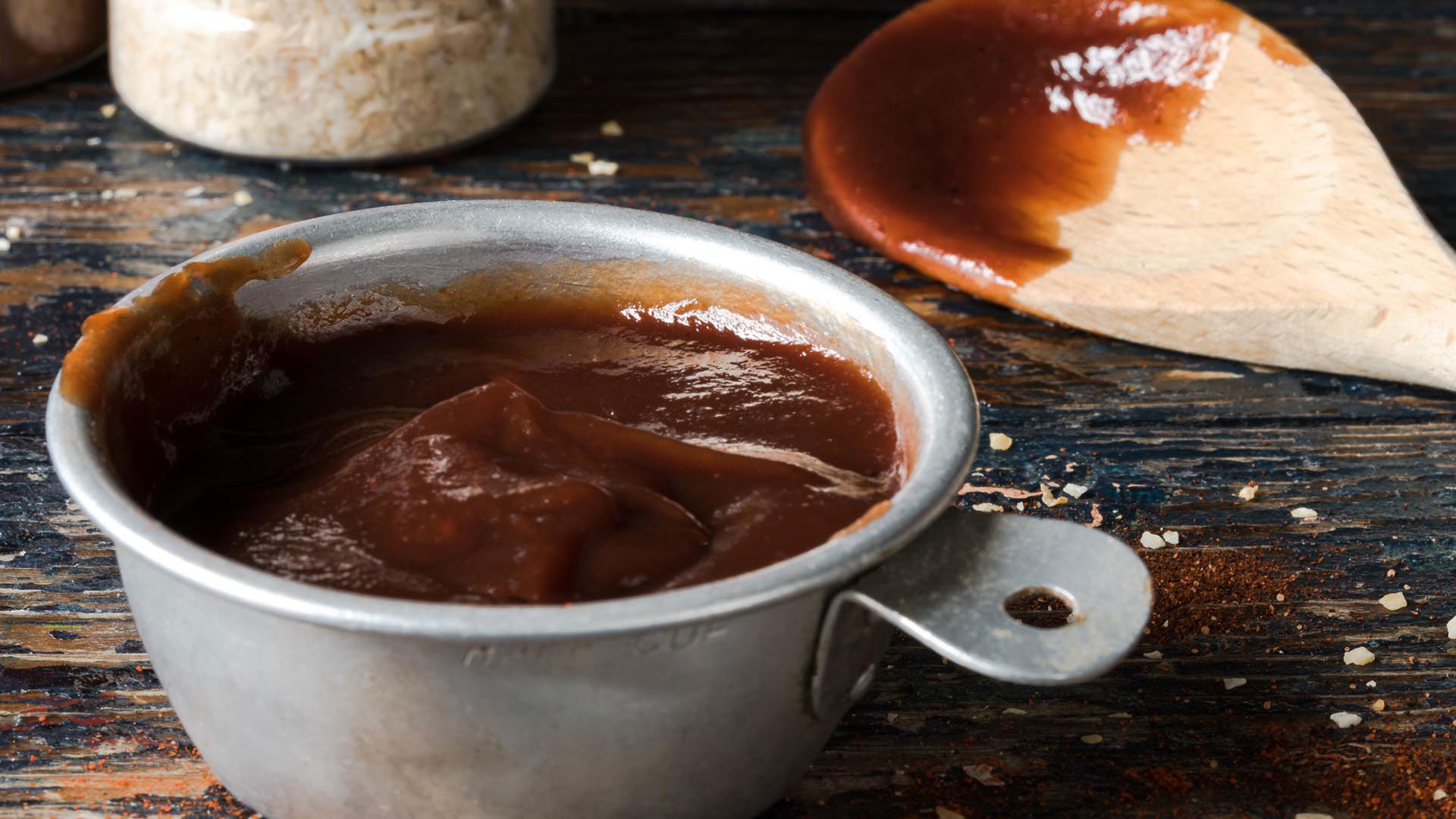 BBQ Sauce in a cup and a spoon
